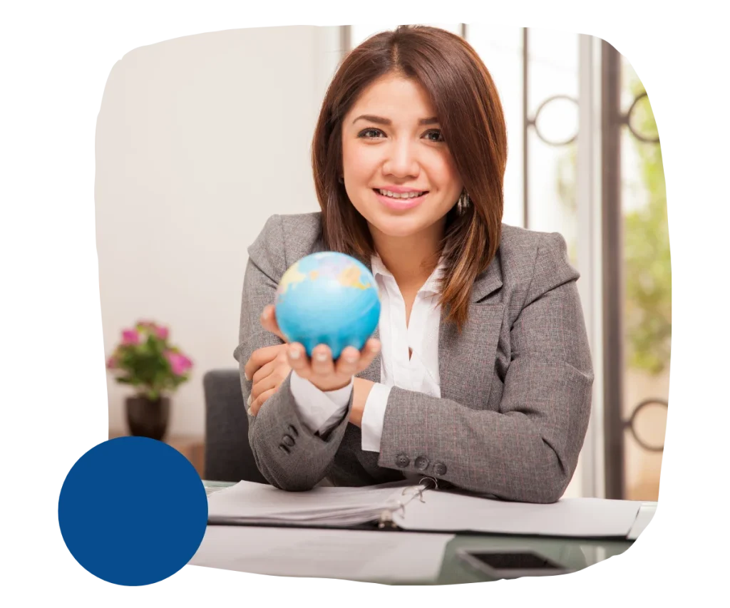 A woman looking at the camera with a globe in her hands